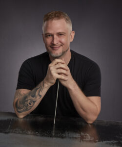 Conductor James Welsch in black tee